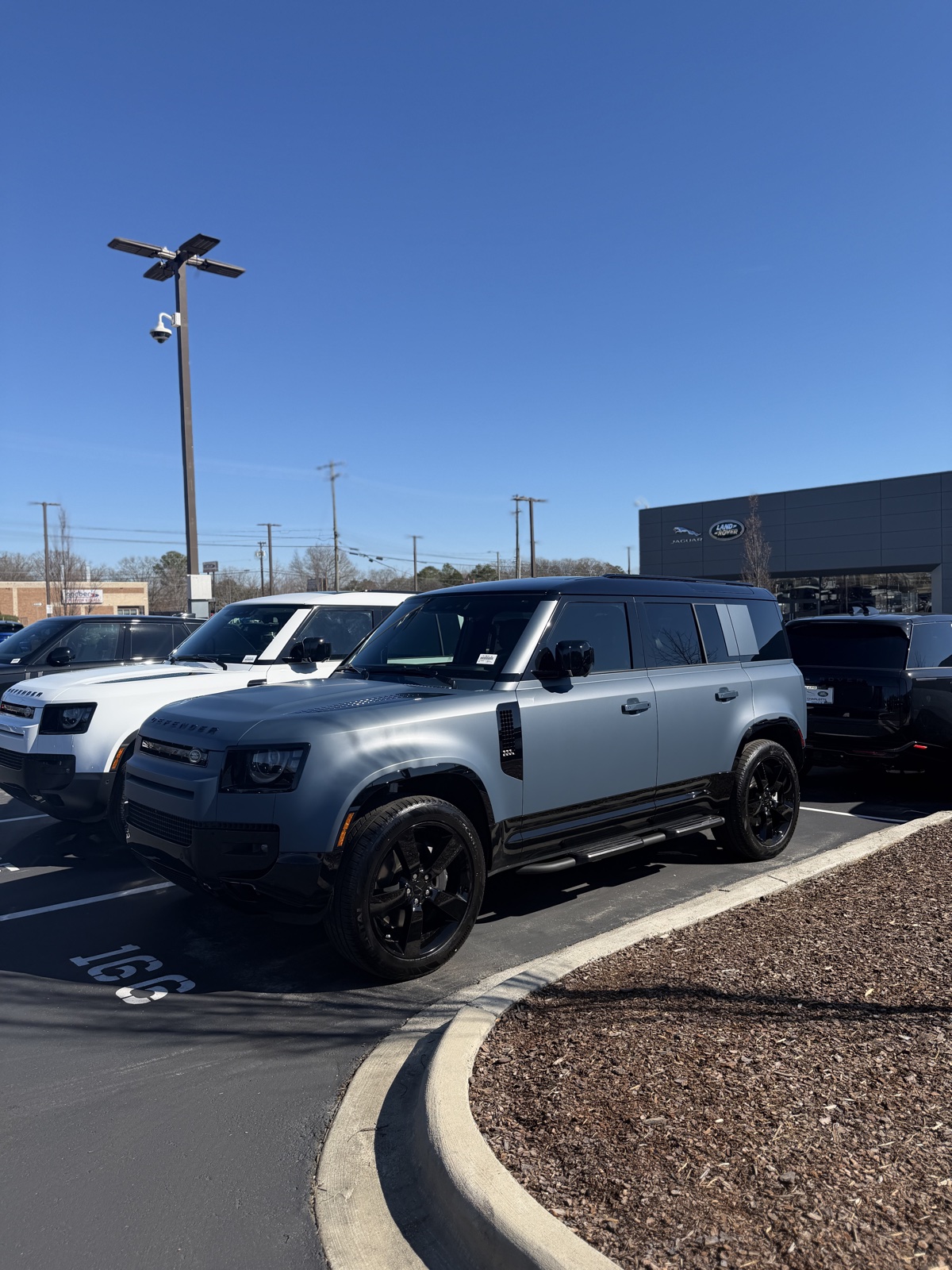 Multiple Land Rover Defender vehicles representing available market inventory